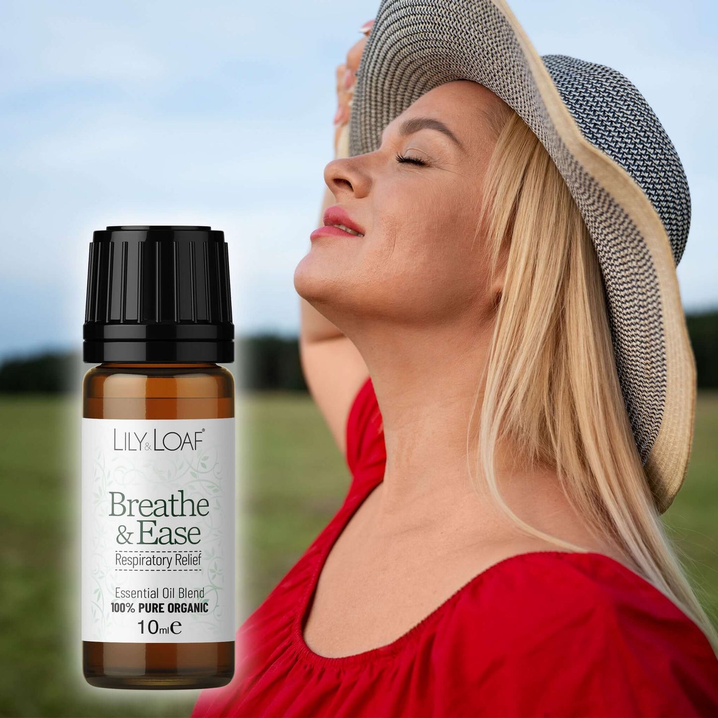 Woman wearing a hat with a bottle of Lily & Loaf Breathe & Ease essential oil blend in the foreground.