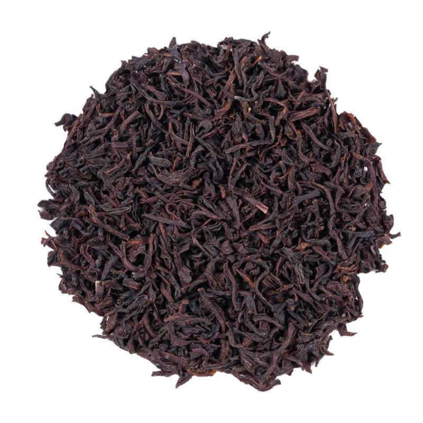 Close-up of Ceylon Orange Pekoe dark brown tea leaves on a white background