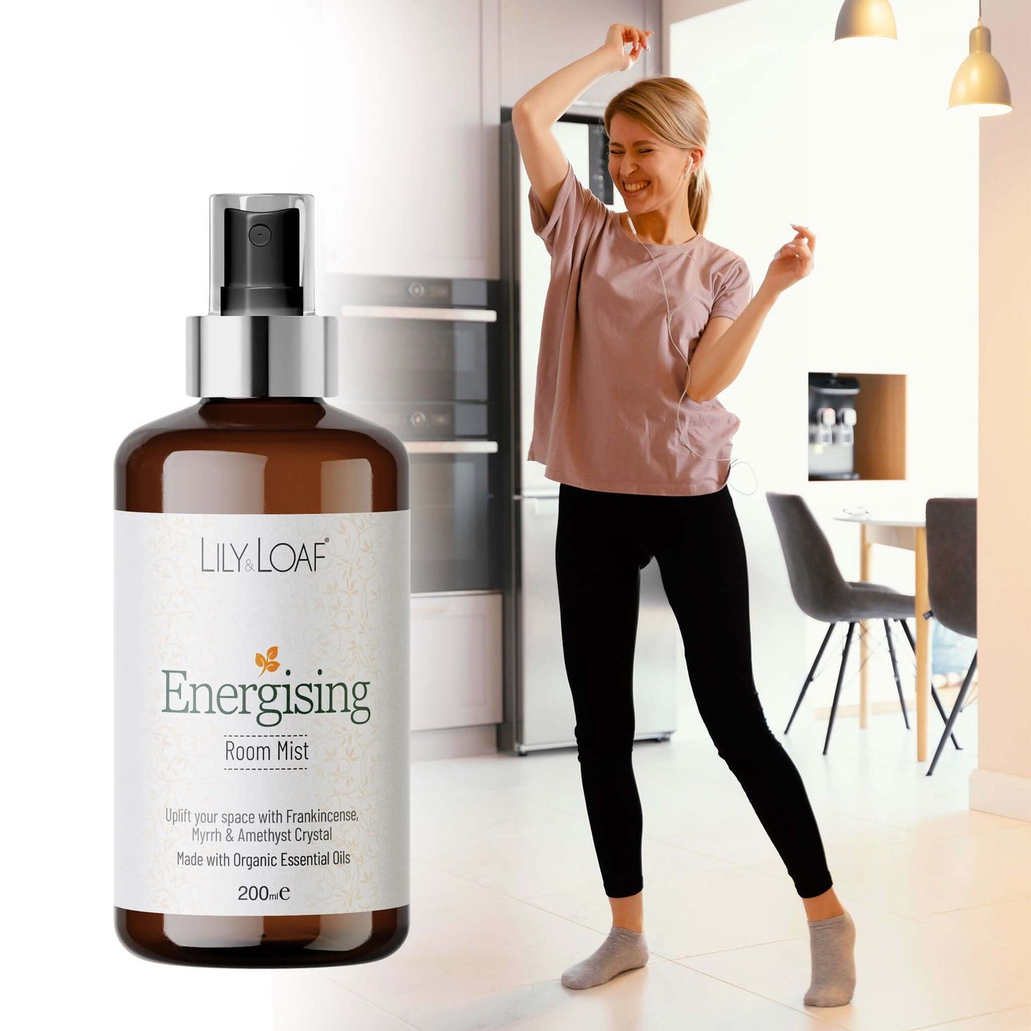 Bottle of Lily Loaf Energising Room Mist with a woman stretching in the background