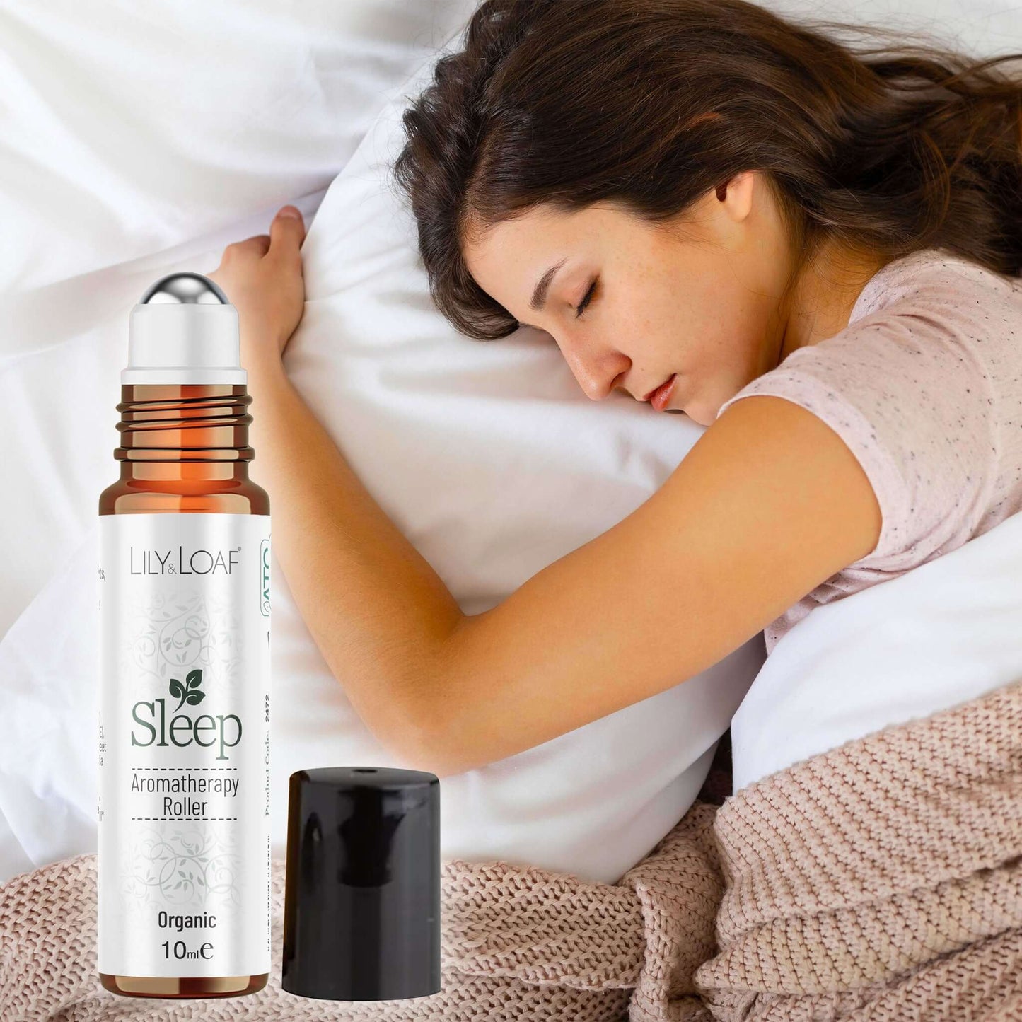 Woman sleeping with a Lily & Loaf Sleep aromatherapy roller bottle in the foreground.
