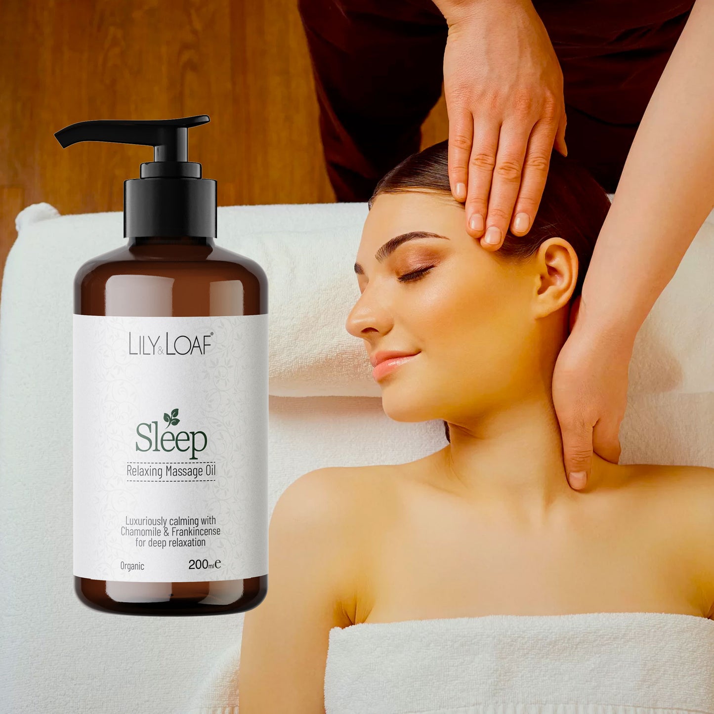 Woman receiving a massage with a bottle of Lily Loaf Sleep Relaxing Massage Oil in the foreground.