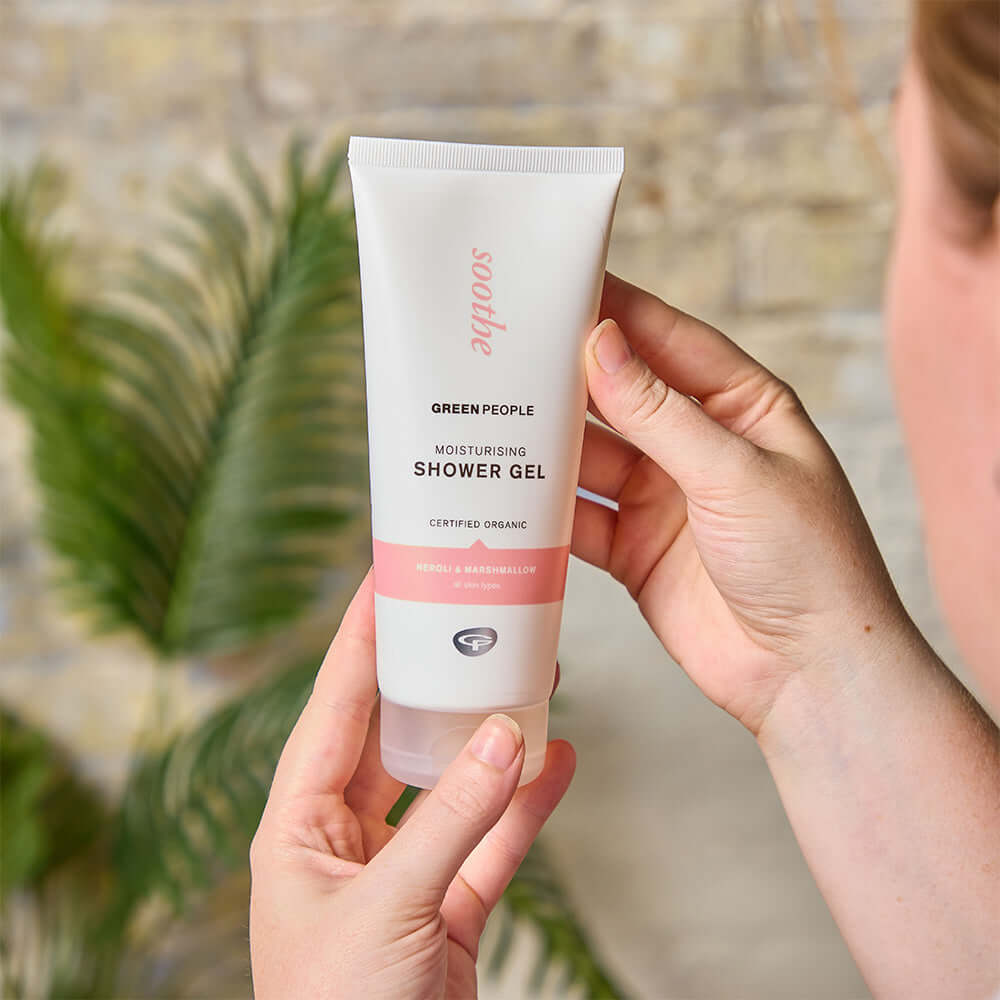 Hands holding Green People Soothe Moisturising Shower Gel with neroli and marshmallow, organic formula for all skin types