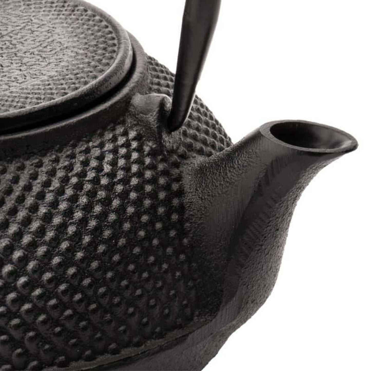 Black textured teapot on a white background close up of the spout