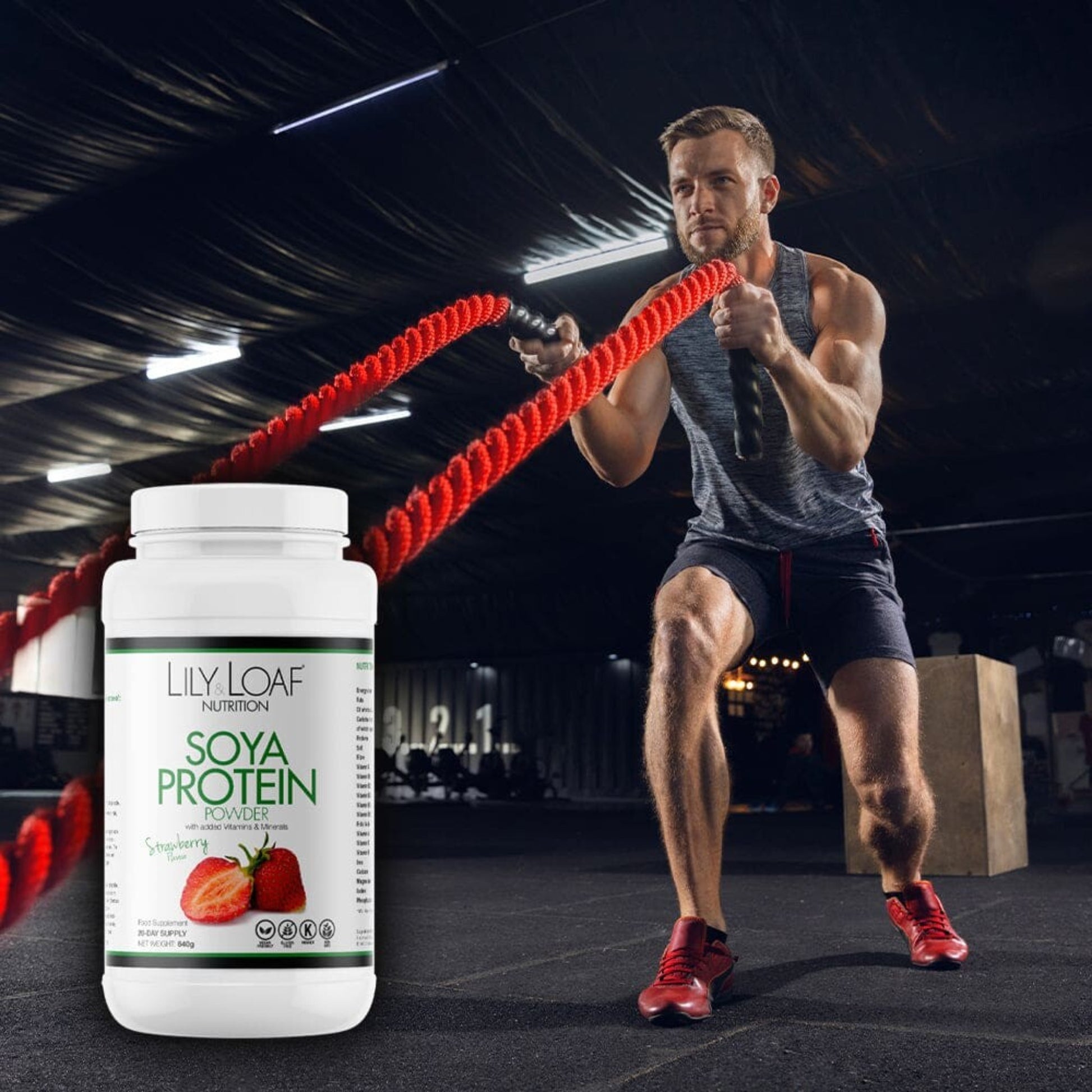 An action-packed image showcasing a fit man engaged in an intense workout with battle ropes, paired with a container of Lily & Loaf Soya Protein Powder, suggesting the product's role in supporting an active and healthy lifestyle.