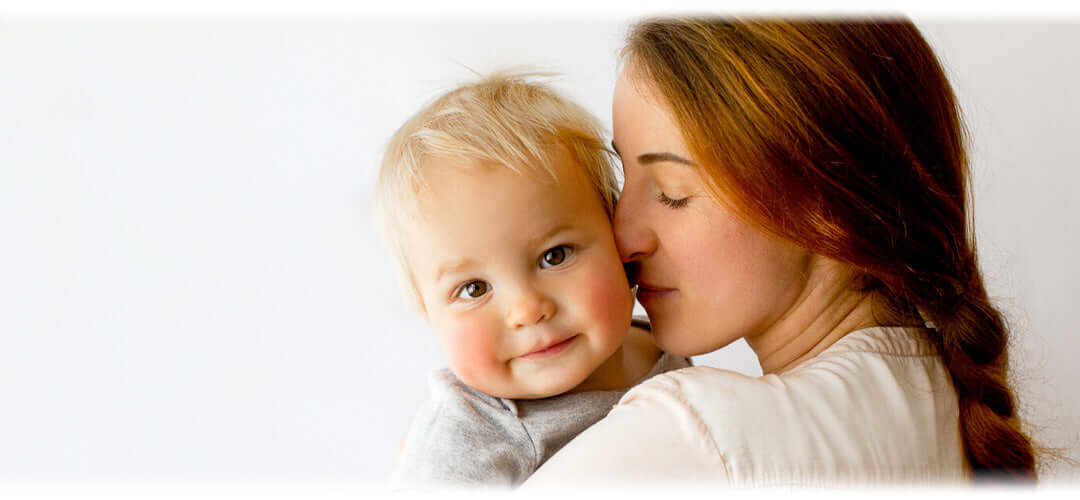 A mother holding her baby affectionately, illustrating the bond between mother and child.