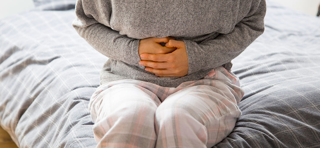 sick-woman-with-hands-stomach-suffering-from-intense-pain