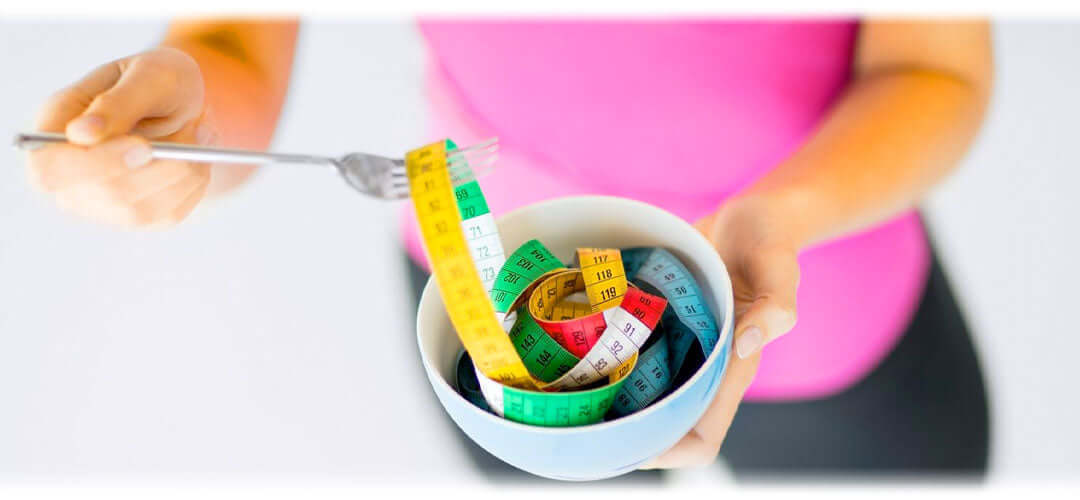 A person eating some measuring tapes, symbolising weight management