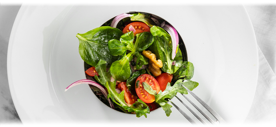 A white plate with a healthy garden salad