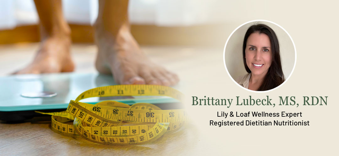 feet on scales with measuring tape infront on floor