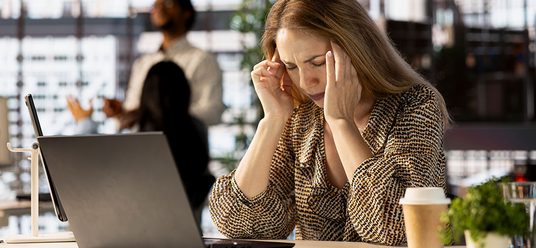 female at work suffering stress and fatigue