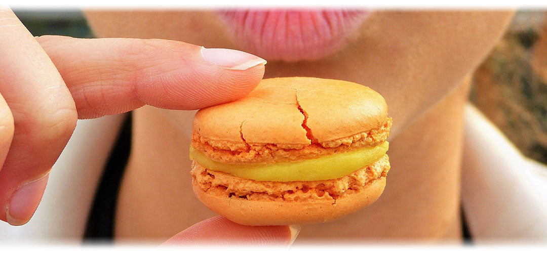 A woman eating a macaroon