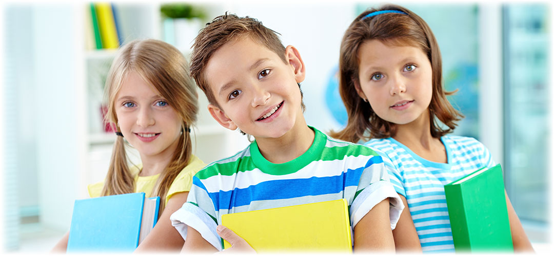 Happy school children holding books, representing tips for boosting kids' immunity and preventing common back-to-school illnesses