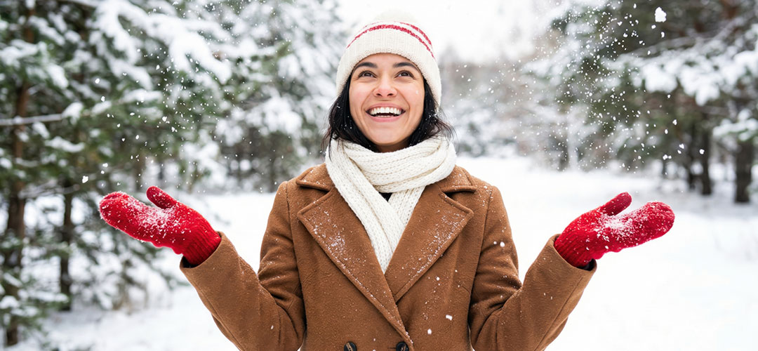 happy-smiling-young-woman-enjoying-a-beautiful-snowy-day-