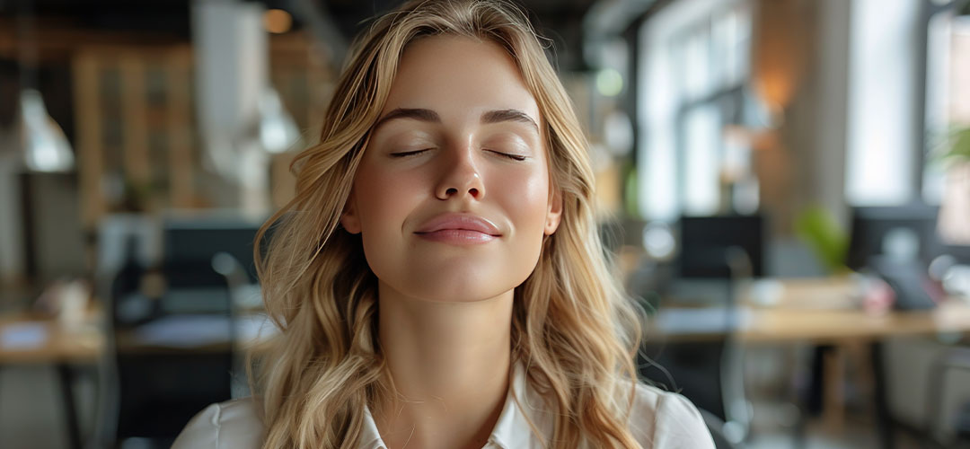 woman-sitting-at-table-with-eyes-closed