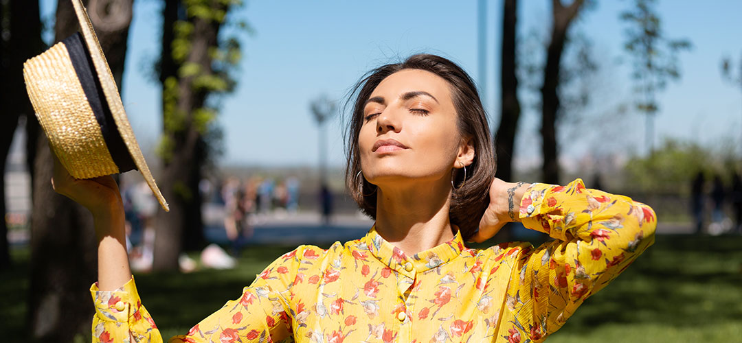 outdoor-fashion-portrait-woman-yellow-summer-dress-hat-sitting-grass-park