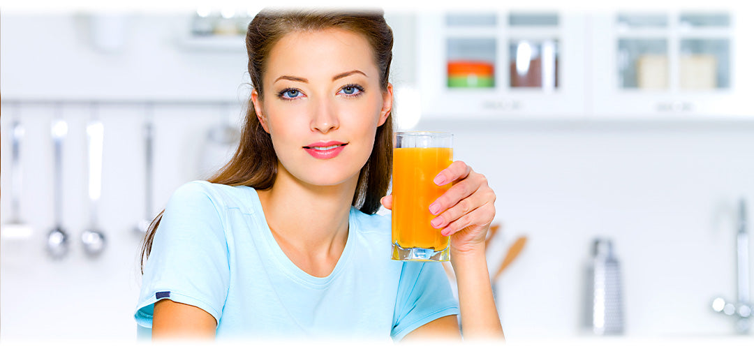 A woman holding a beverage in her hand, possibly a refreshing drink