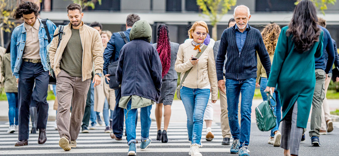 mixed aged people walking in a city