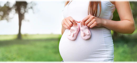 An image featuring a pregnant woman holding her belly. The image suggests the topic of pregnancy and related issues