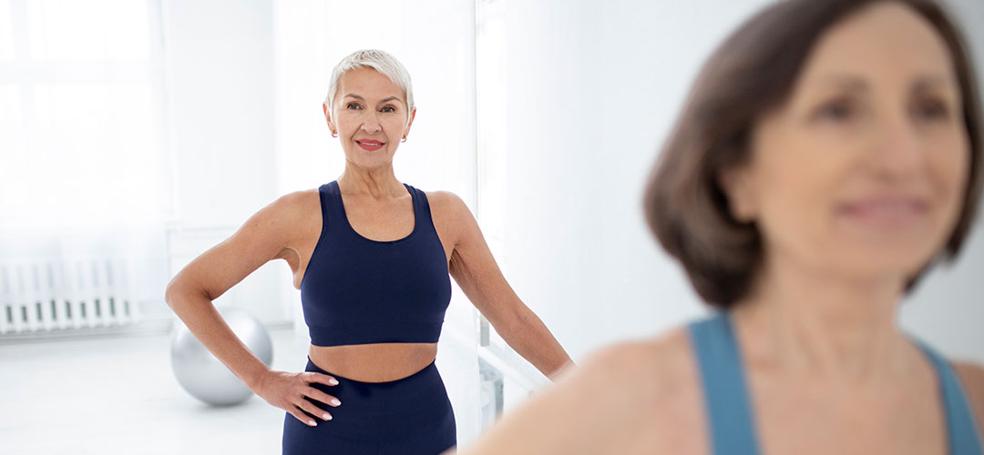 Confident middle-aged women in a fitness class, showcasing exercises and routines designed to help achieve a strong, toned body