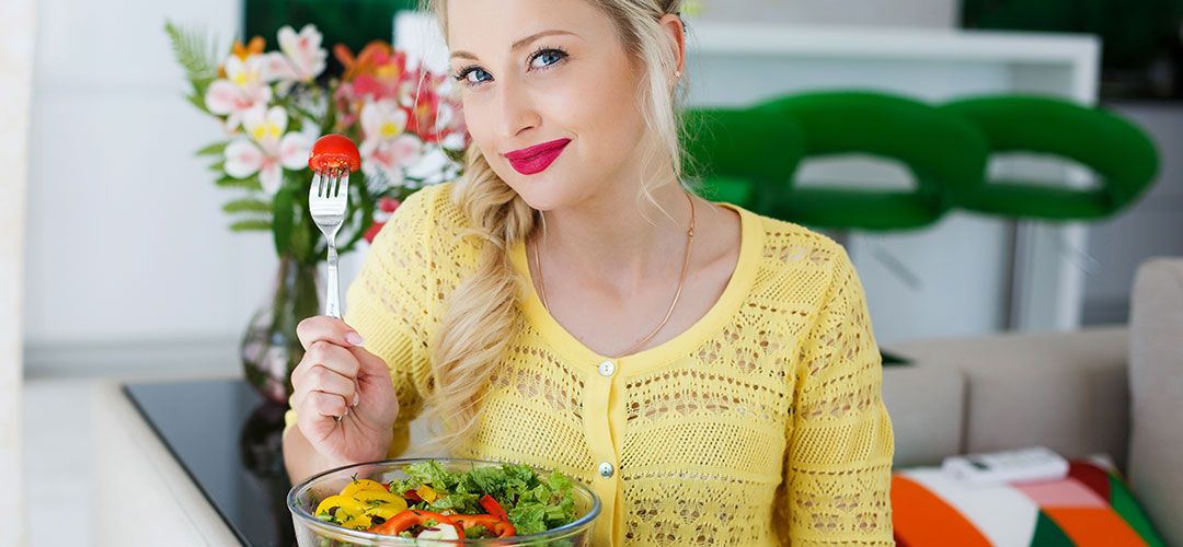 lady at home on spring day eating a salad