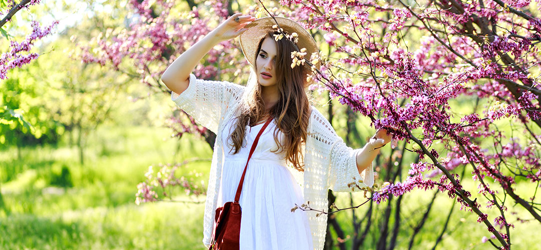 charming-pretty-young-woman-with-long-hair-summer-hat-white-light-dress-walking-sunny-garden-blooming-sakura-background-relaxation-smiling-camera-light-clothes-sensitive-joy