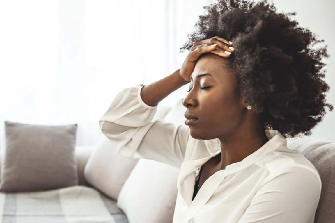 A woman holding her head with a distressed expression