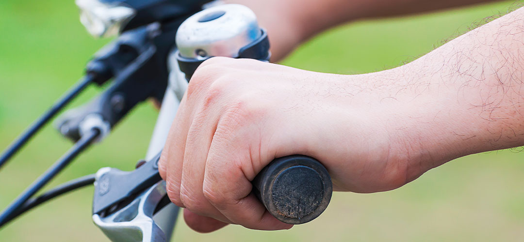 closeup-boy-hand-riding-bicycle-photo-is-focused-nearest-hand