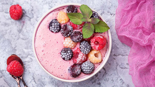 Berry and maca protein smoothie topped with fresh berries in a breakfast bowl