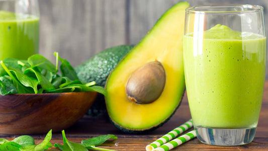 Green smoothie with avocado, spinach and pineapple served in a glass.