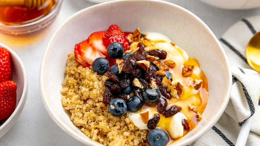 Fruit and quinoa breakfast bowl with berries, banana and roasted almonds.