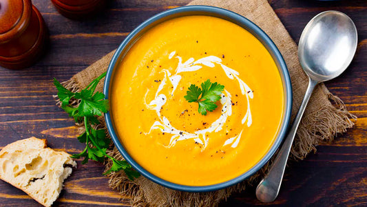 Bowl of homemade carrot and coriander soup garnished with fresh coriander