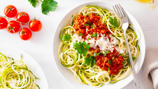 Homemade beef bolognese sauce served in a bowl with fresh herbs