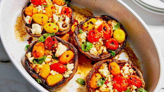 Stuffed portobello mushrooms topped with feta cheese and cherry tomatoes