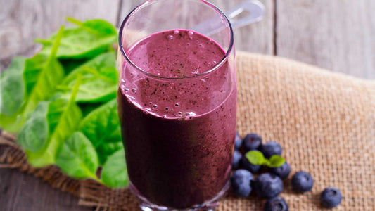 A glass of spinach and blueberry smoothie