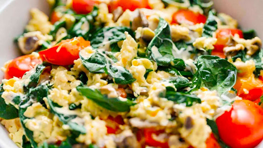 Scrambled eggs with spinach, rocket and cherry tomatoes