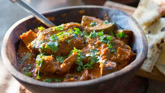 Tomato and coconut beef curry topped with fresh coriander