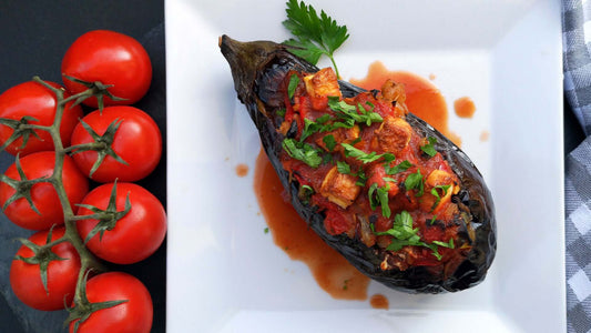 Stuffed aubergine rolls baked in tomato sauce with basil