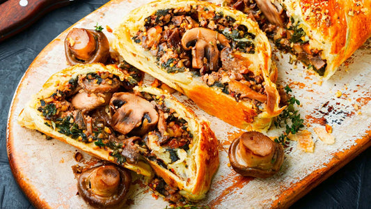 Mushroom, goat's cheese, spinach and chestnut Wellington sliced and served