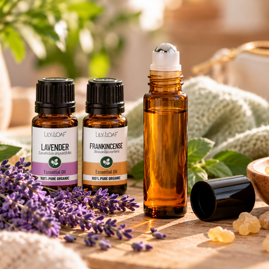 Lavender and Frankincense essential oil roller bottle with lavender flowers, frankincense resin and amber essential oil bottles