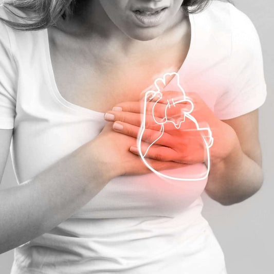 A woman clutching her heart in pain