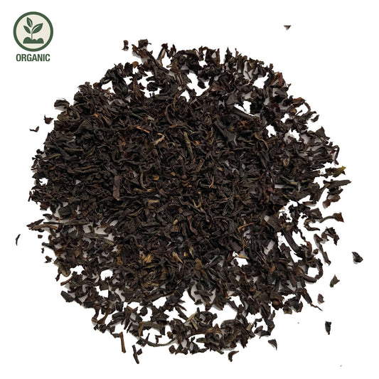 Close-up of loose-leaf Assam Sewpur Organic Black Tea, displaying the dried ingredients and natural texture of the blend.