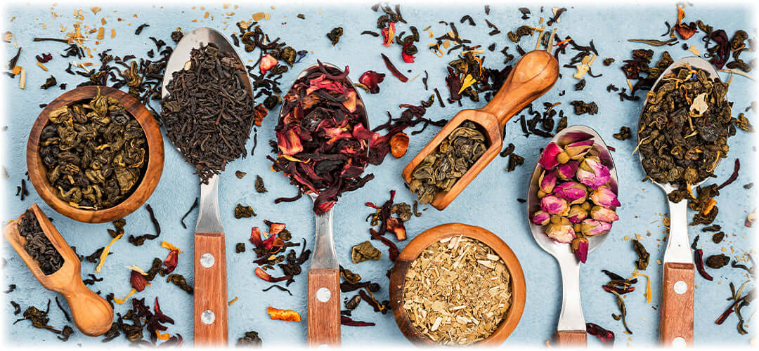 mixture of herbal remedies in spoons on table