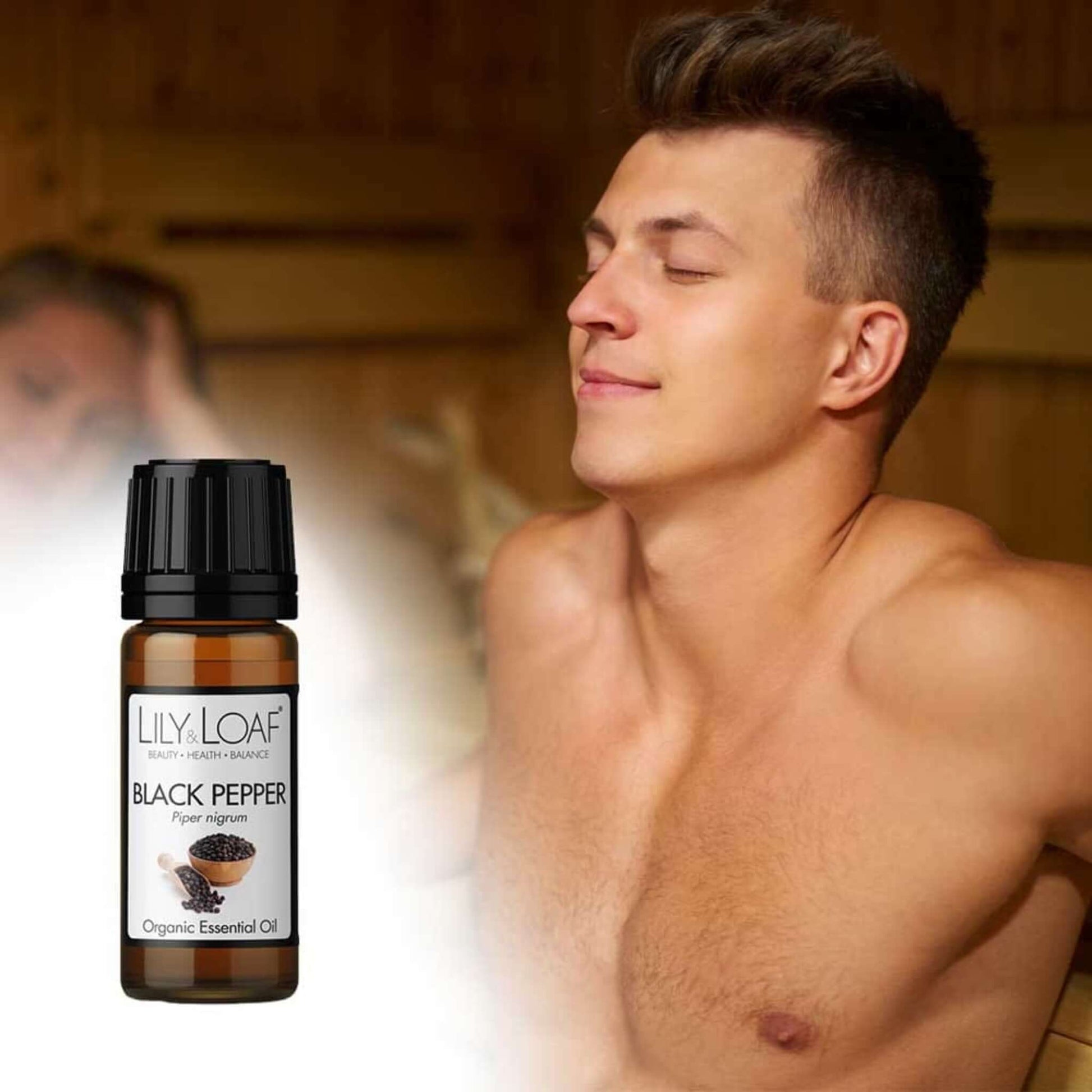 A man enjoying a sauna with an image of Lily & Loaf Black Pepper Organic Essential Oil 