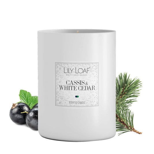 Lily & Loaf Cassis and White Cedar Soy Wax Candle surrounded by cassis berries and cedar sprigs highlighting the botanical fragrance
