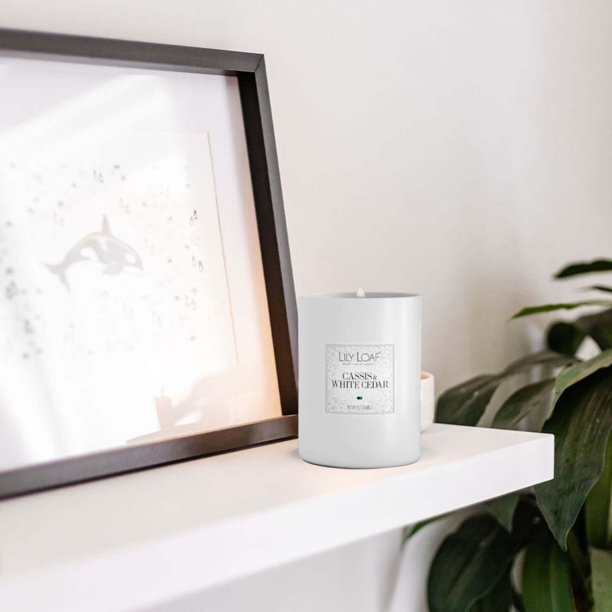 Cassis and White Cedar Soy Wax Candle on a living room mantlepiece