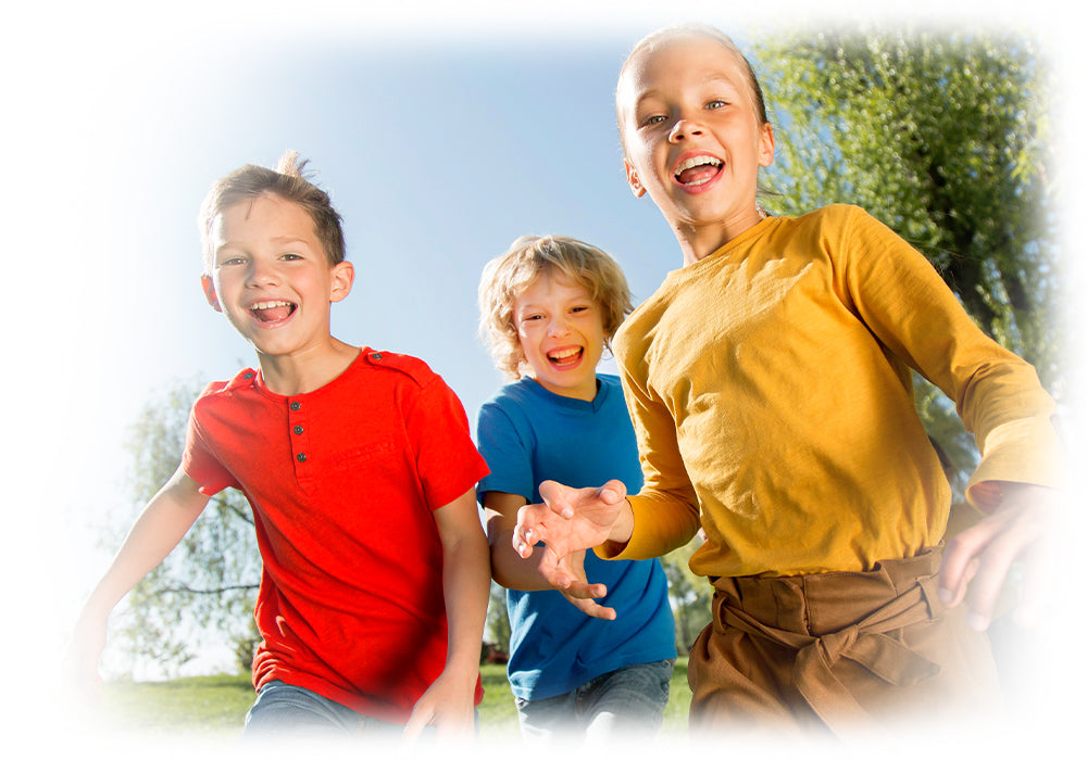 Three lively children running joyfully, symbolizing Lily & Loaf's dedication to active and happy lifestyles.