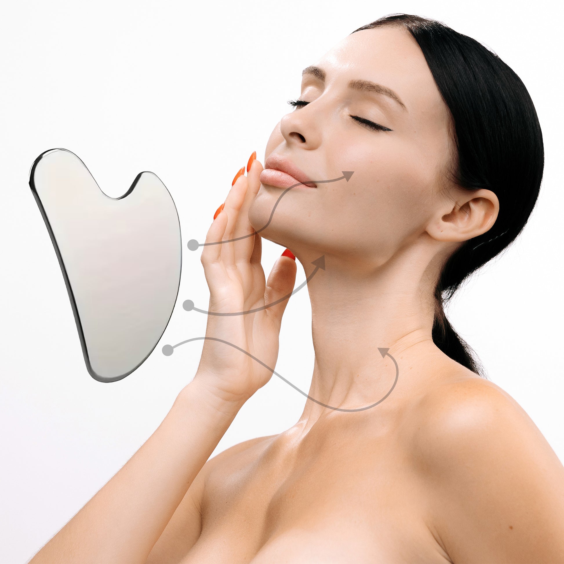 Woman using a gua sha tool on her face with a white background