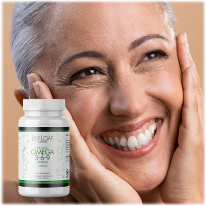Smiling woman with hands on her face next to a bottle of Lily & Loaf Organic Omega 3-6-9 supplement with Vitamin E, promoting beauty and health.