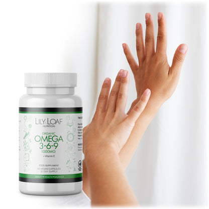 Woman's hands with smooth skin next to a bottle of Lily & Loaf Organic Omega 3-6-9 supplement with Vitamin E, highlighting benefits for skin health.