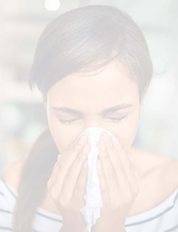 lady sneezing into a handkerchief